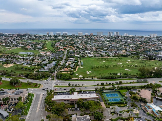 birds eye view of property featuring golf course view and a water view