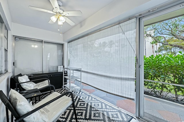 sunroom featuring ceiling fan