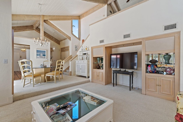 living area featuring visible vents, carpet floors, and an inviting chandelier