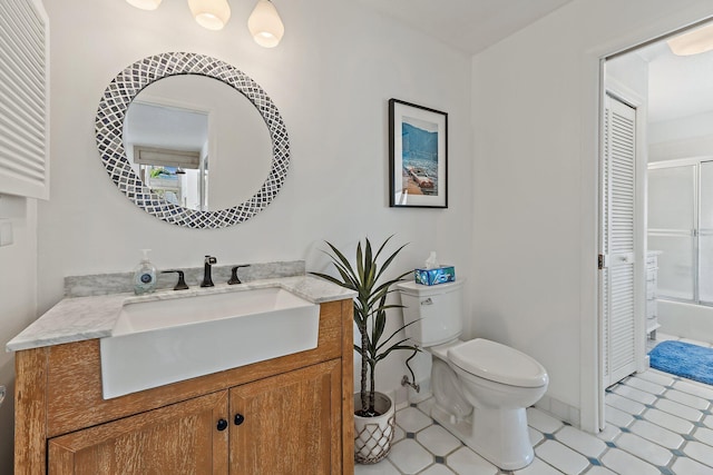 bathroom featuring tile patterned floors, toilet, and vanity