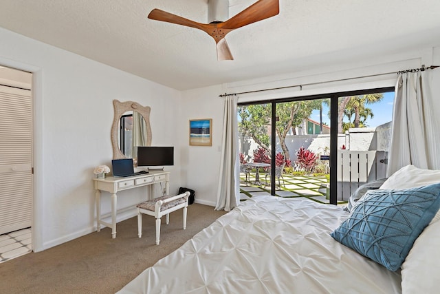 bedroom featuring a ceiling fan, baseboards, carpet floors, a textured ceiling, and access to outside