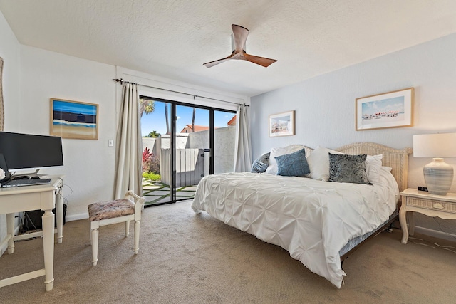 carpeted bedroom with baseboards, a textured ceiling, and access to outside