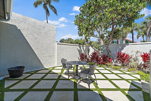 view of patio with outdoor dining area and a fenced backyard