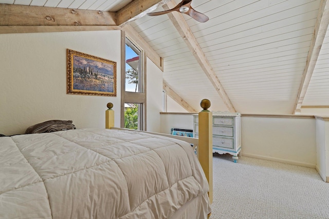 carpeted bedroom with lofted ceiling with beams, baseboards, and ceiling fan