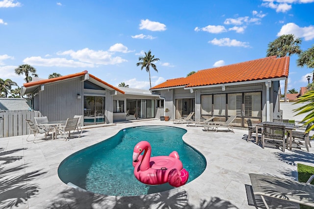 view of pool featuring a fenced in pool, a patio area, fence, and a sunroom