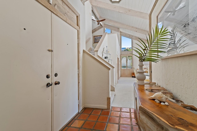 tiled foyer entrance featuring stairway, wood ceiling, and vaulted ceiling with beams