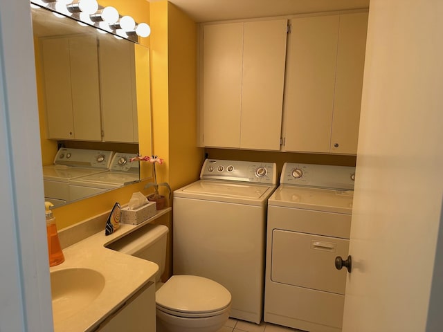 half bathroom featuring independent washer and dryer, toilet, and a sink