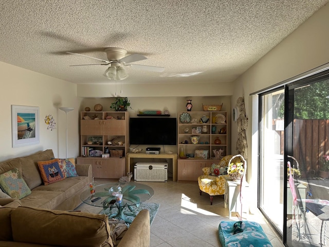 living room featuring ceiling fan, a textured ceiling, and light tile patterned flooring