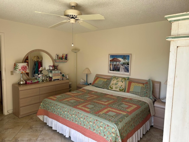 bedroom with light tile patterned flooring, a textured ceiling, and ceiling fan