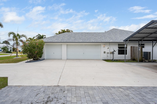 view of front of house with roof with shingles, a garage, driveway, and stucco siding