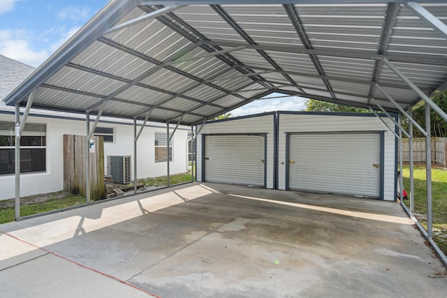 detached garage with central AC unit and fence