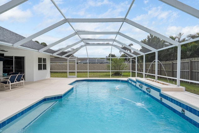view of swimming pool with a patio area, a fenced in pool, glass enclosure, and a fenced backyard