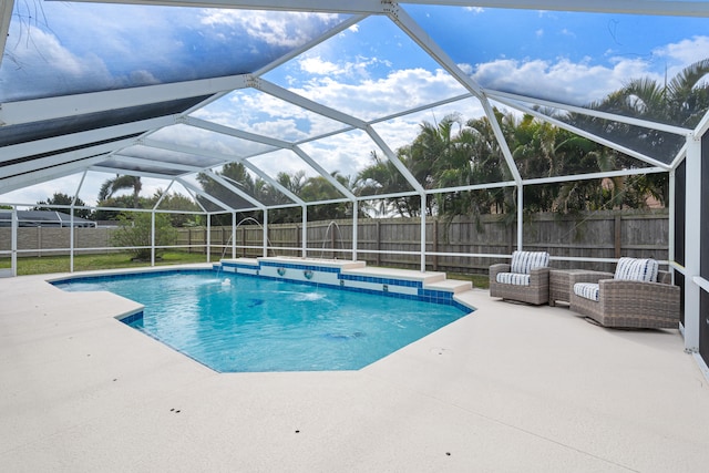 view of swimming pool with a patio, a fenced backyard, a fenced in pool, and a lanai