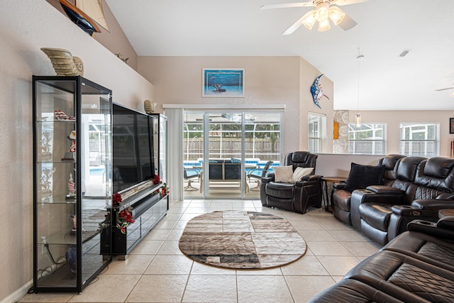 living room featuring tile patterned floors, visible vents, high vaulted ceiling, and a ceiling fan