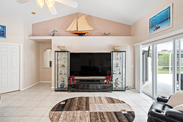 living area with tile patterned floors, baseboards, ceiling fan, and vaulted ceiling