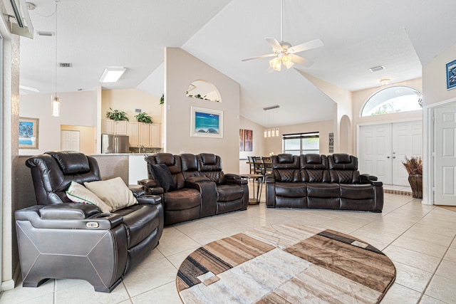 living area with light tile patterned flooring, visible vents, high vaulted ceiling, and a ceiling fan