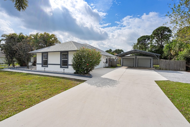 ranch-style house featuring a front yard, fence, stucco siding, concrete driveway, and a garage