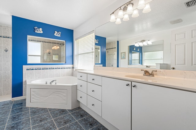 bathroom with visible vents, plenty of natural light, a walk in shower, and a textured ceiling