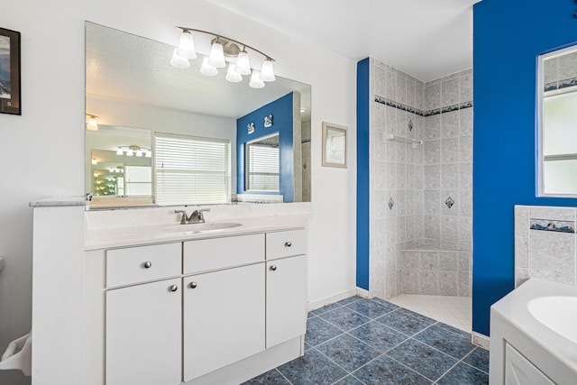 bathroom with walk in shower, vanity, a garden tub, tile patterned floors, and a textured ceiling