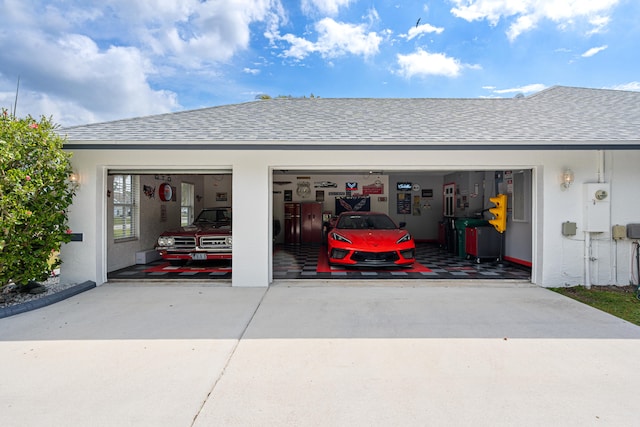 garage featuring concrete driveway