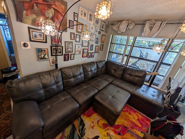 living area featuring a textured ceiling and a chandelier