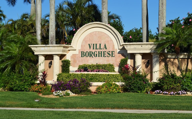 community / neighborhood sign featuring a lawn