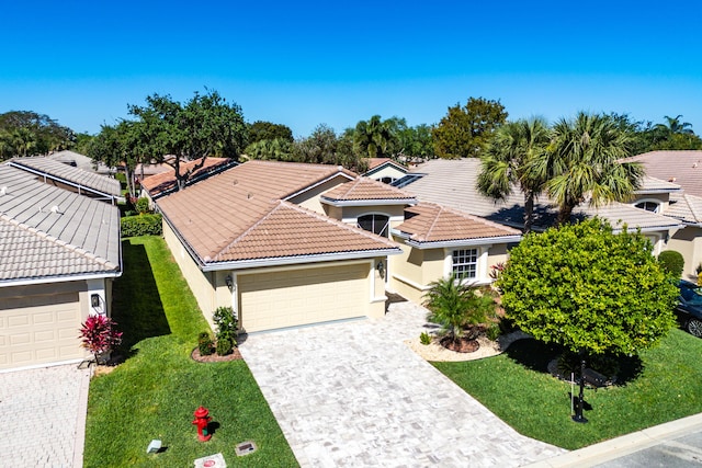 13853 Via Da Vinci, Delray Beach, FL 33446 - view of front of house with stucco siding, a garage, a front yard, a tile roof, and decorative driveway