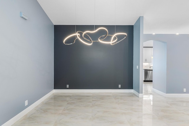 13853 Via Da Vinci, Delray Beach, FL 33446 - spare room with arched walkways, light marble finish floors, a chandelier, and baseboards