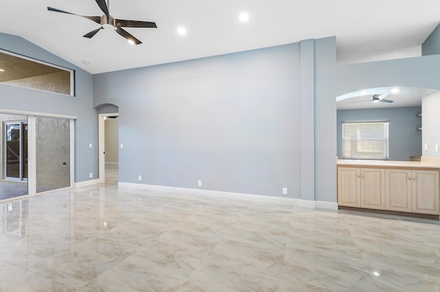 13853 Via Da Vinci, Delray Beach, FL 33446 - unfurnished living room with ceiling fan, arched walkways, light marble finish flooring, and high vaulted ceiling