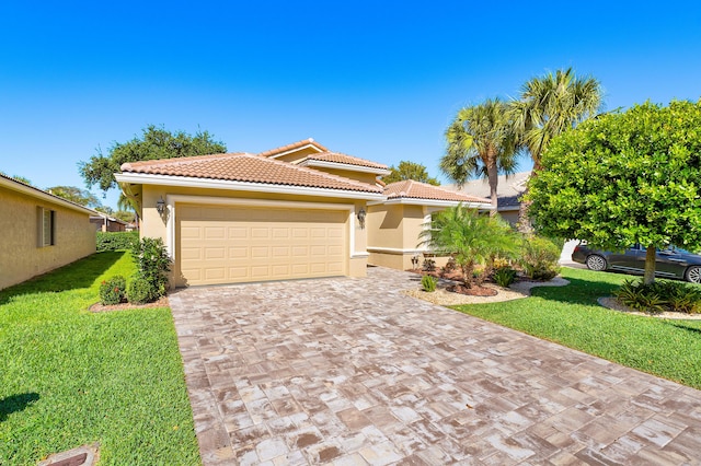 13853 Via Da Vinci, Delray Beach, FL 33446 - mediterranean / spanish house featuring decorative driveway, a front lawn, a tile roof, a garage, and stucco siding