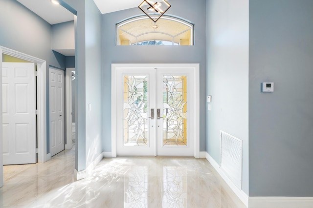 13853 Via Da Vinci, Delray Beach, FL 33446 - entrance foyer featuring french doors, baseboards, and a high ceiling