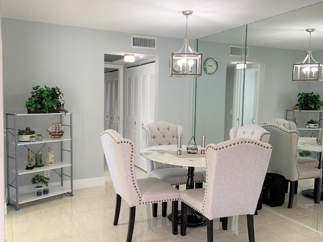 dining room featuring an inviting chandelier, baseboards, and visible vents