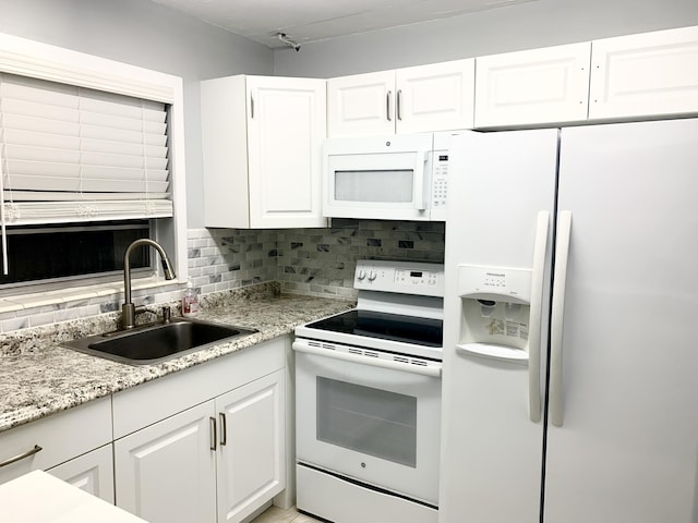 kitchen featuring a sink, decorative backsplash, white appliances, and white cabinetry