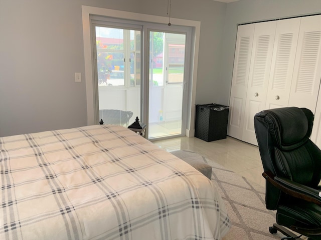 bedroom featuring light tile patterned floors and a closet