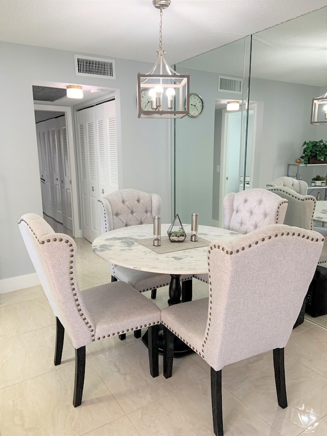 dining space featuring light tile patterned floors, visible vents, baseboards, and an inviting chandelier