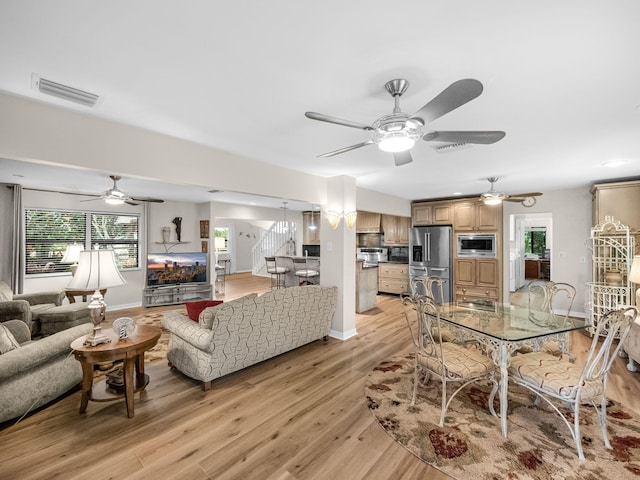 interior space featuring plenty of natural light, a ceiling fan, visible vents, and light wood finished floors