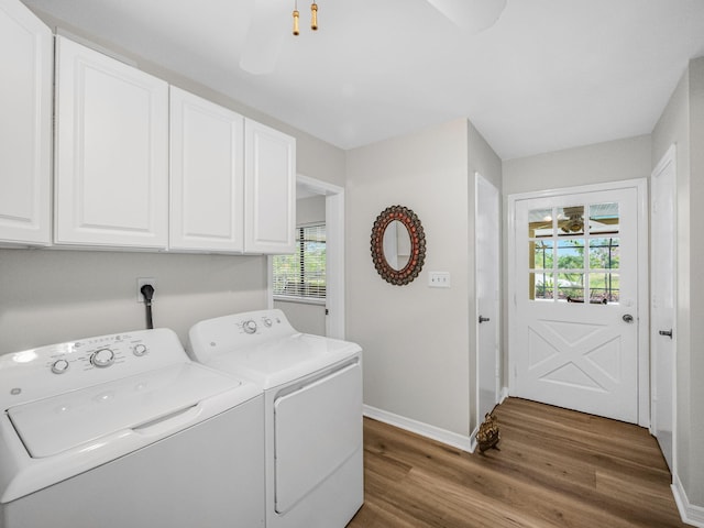 washroom with wood finished floors, cabinet space, independent washer and dryer, and baseboards