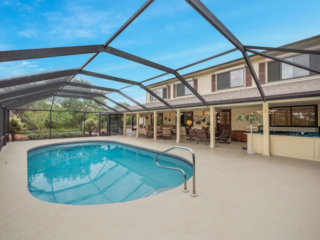 outdoor pool with a patio area and a lanai