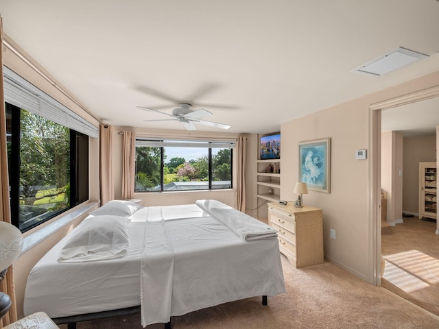 bedroom featuring light colored carpet, baseboards, and ceiling fan