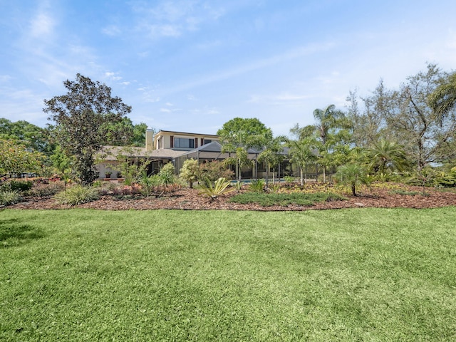 view of yard featuring glass enclosure