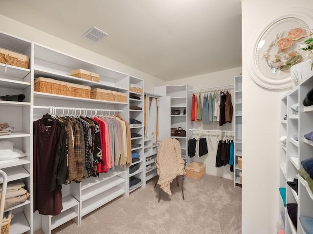 walk in closet with visible vents and carpet