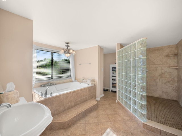 full bathroom featuring a sink, a walk in shower, a garden tub, tile patterned floors, and a chandelier