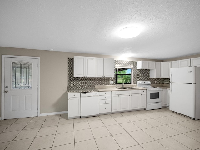 kitchen featuring a sink, white appliances, light countertops, light tile patterned floors, and decorative backsplash