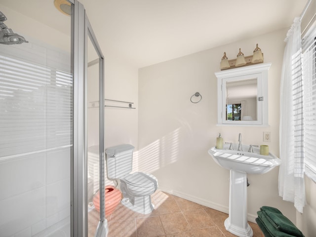 full bath with baseboards, a stall shower, and tile patterned flooring