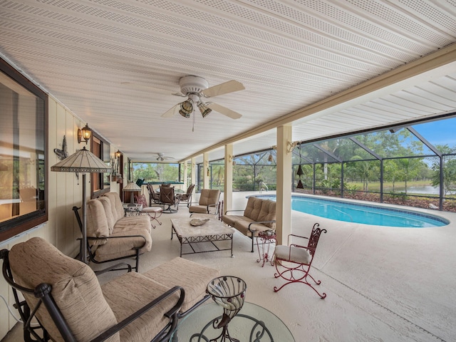 outdoor pool featuring an outdoor living space, glass enclosure, a patio, and ceiling fan