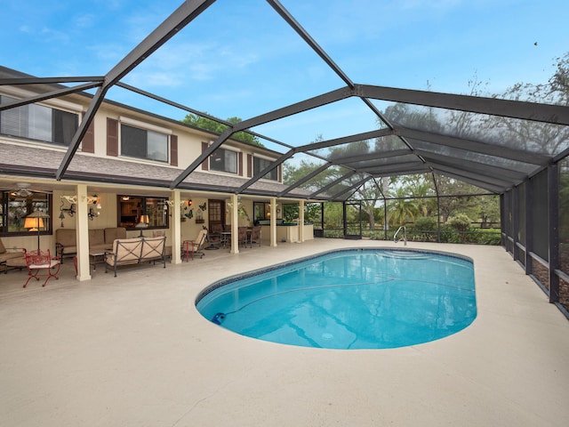 pool featuring a patio area, an outdoor living space, and a lanai