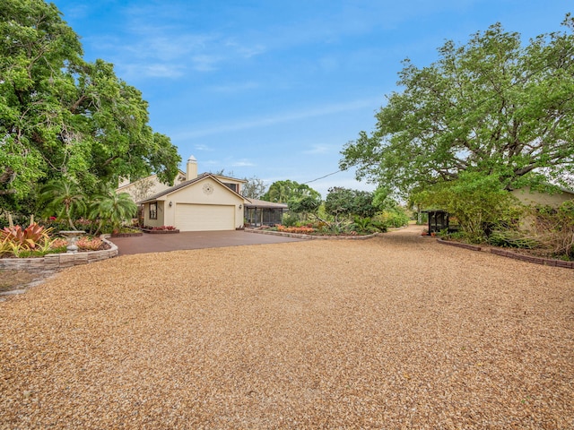 view of front facade with stucco siding, driveway, and an attached garage