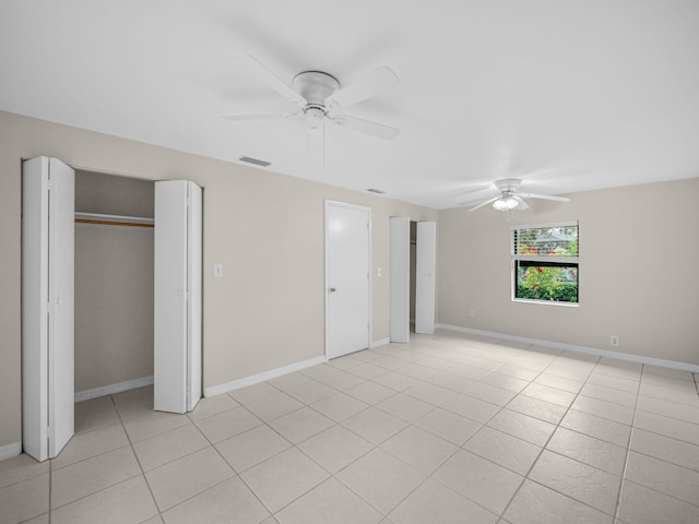 unfurnished bedroom with a ceiling fan, light tile patterned flooring, baseboards, and visible vents
