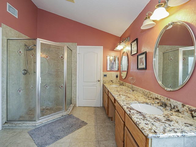 bathroom featuring a sink, visible vents, lofted ceiling, and a stall shower