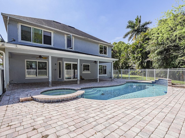 view of swimming pool featuring a ceiling fan, a pool with connected hot tub, a patio area, and a fenced backyard